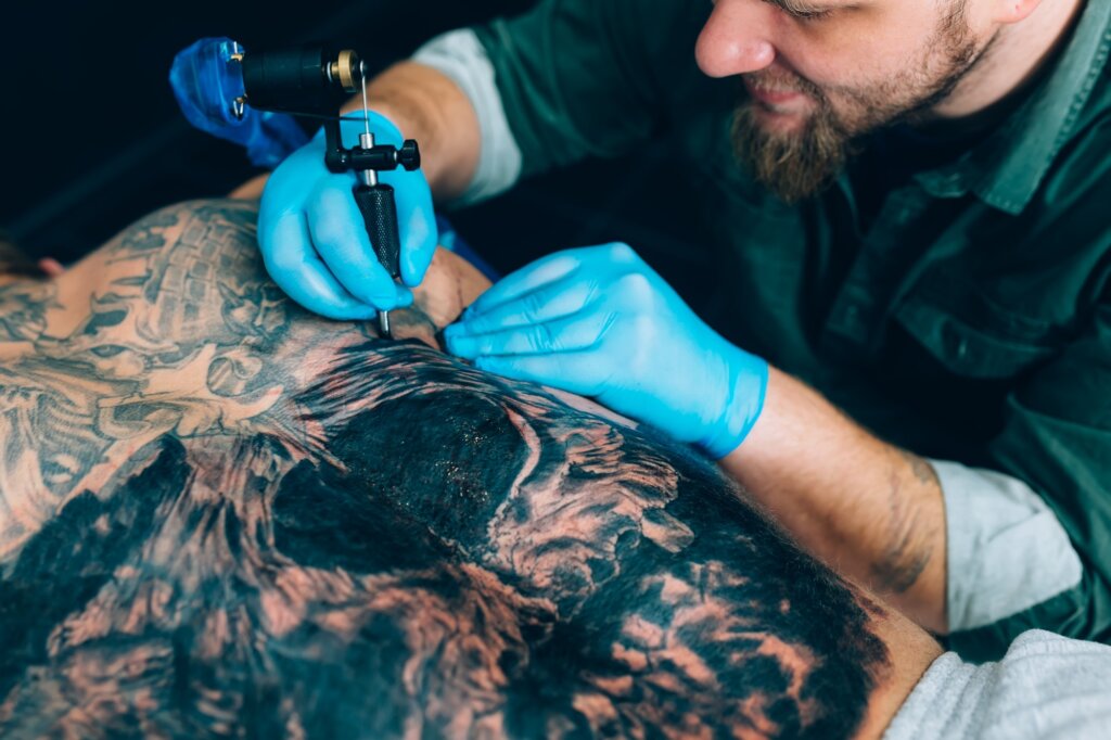 tattoo master artist makes a tattoo. Closeup