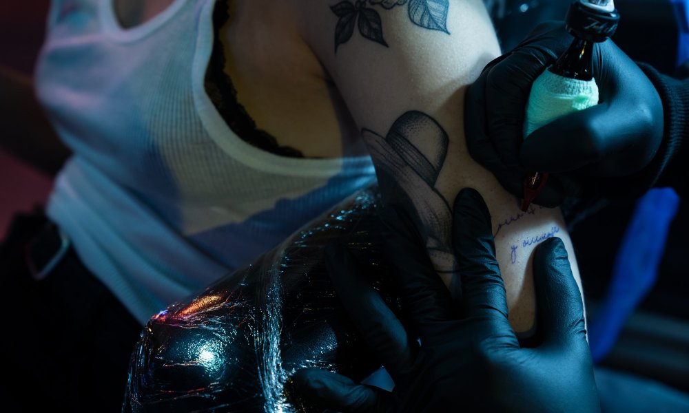 Close Up Of Needle And Ink For Tattoo On Skin