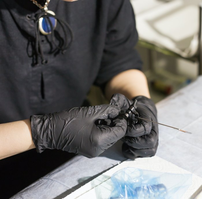 master tattoo artist prepares tools for tattooing