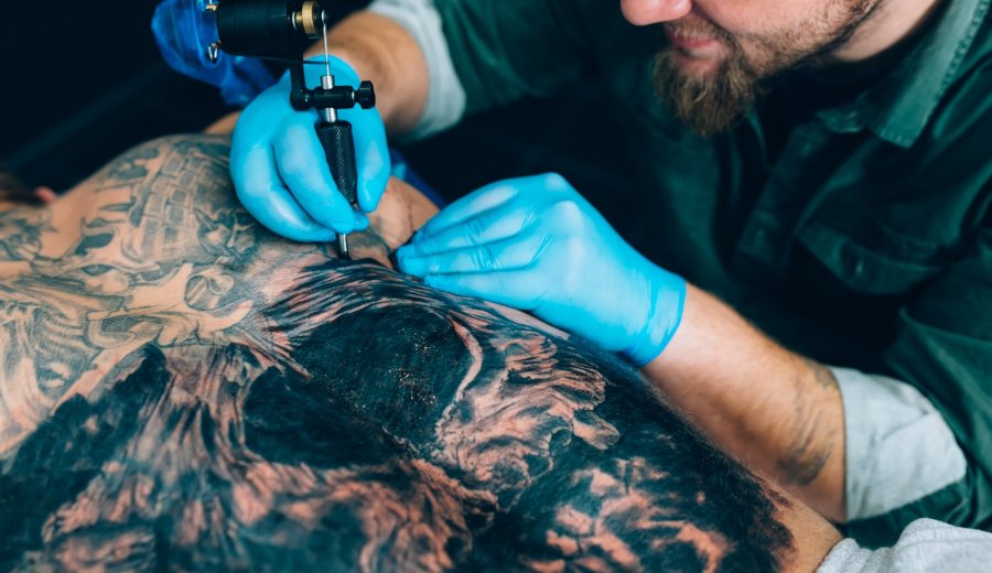 tattoo master artist makes a tattoo. Closeup