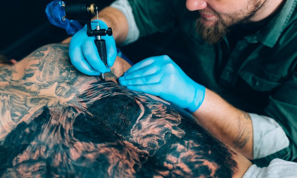 tattoo master artist makes a tattoo. Closeup